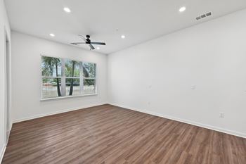 A room with a ceiling fan and a window with blinds at The Concord Luxury Apartments, Sarasota, FL